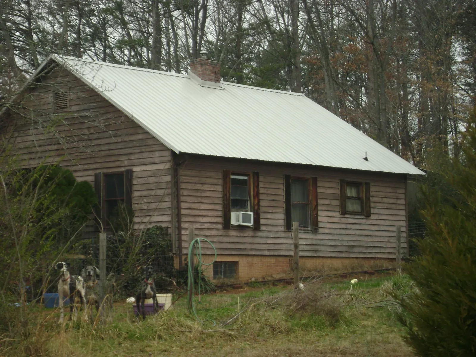 White metal roof on an old wood sided farmhouse, from a Asphalt Shingle Roof Repair job in Pickerington